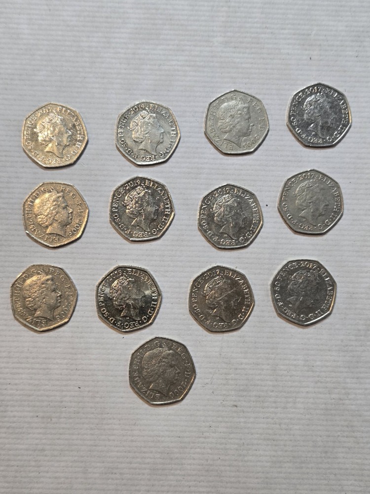 13 50p coins with various designs on the back
