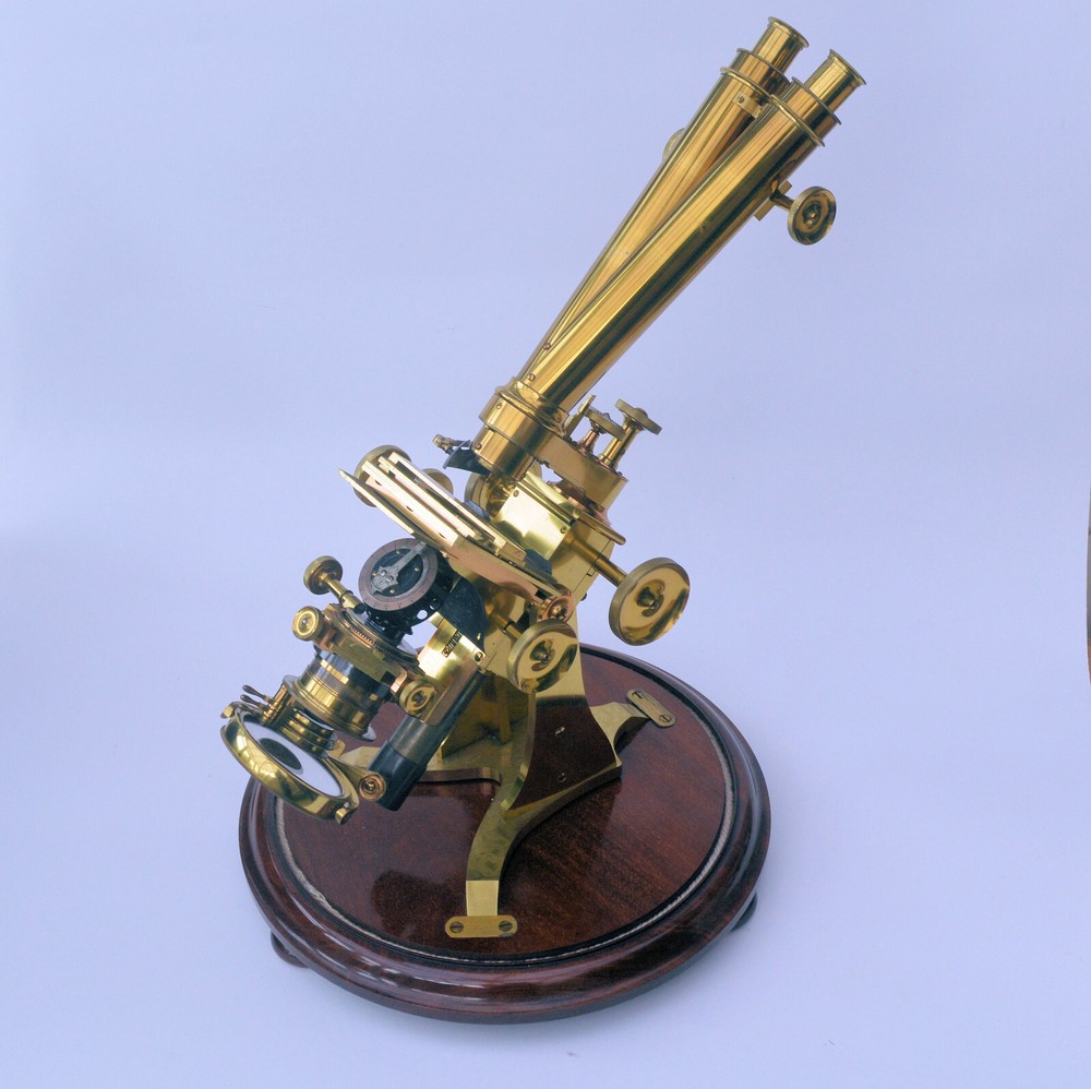 Very large binocular microscope in case with accessories.