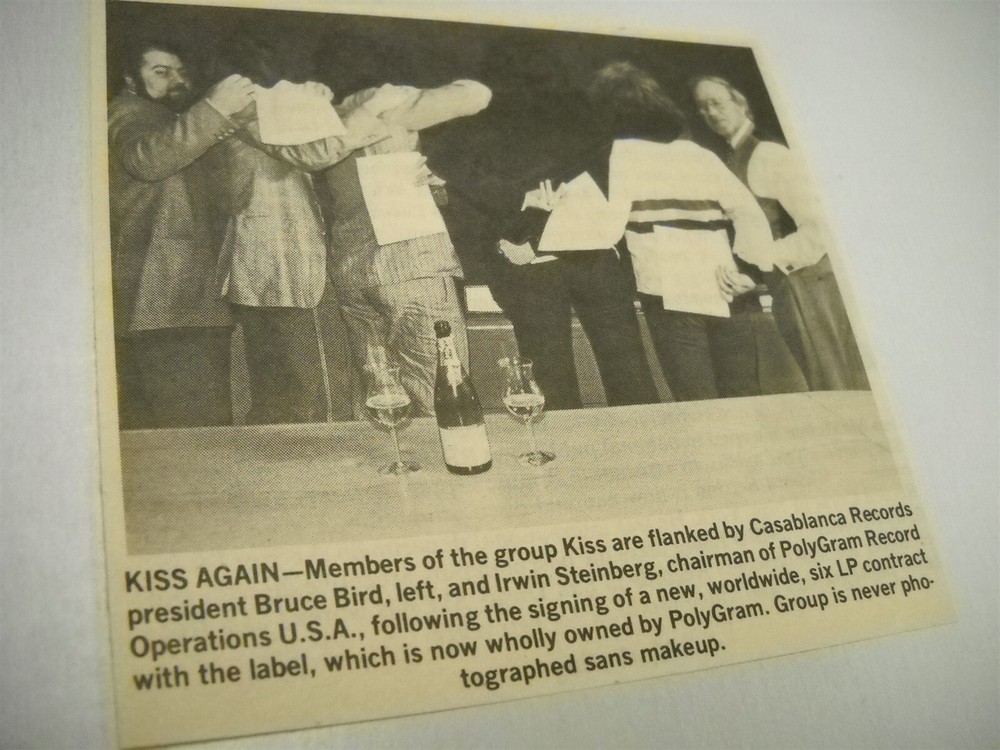 KISS turn backs and hide faces to sign contract 1980 music biz promo pic/text