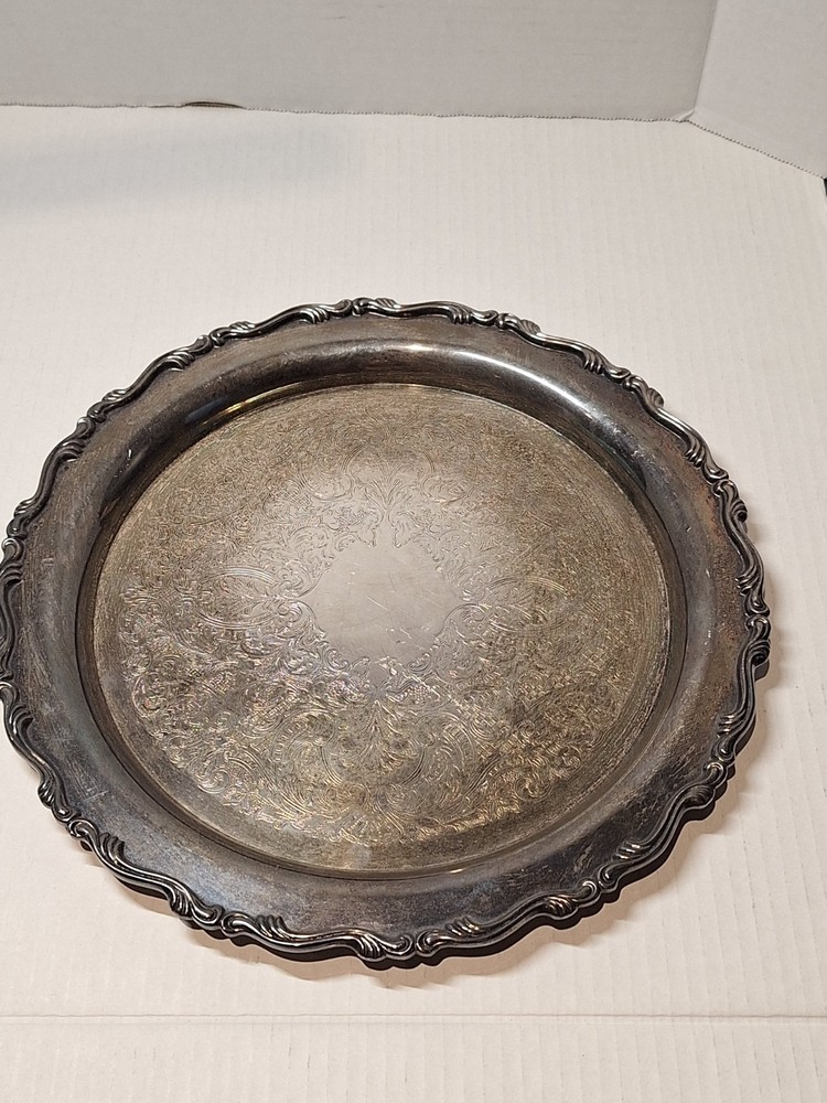 Oneida silver serving platter. Two lions mark pattern. 12” diameter.