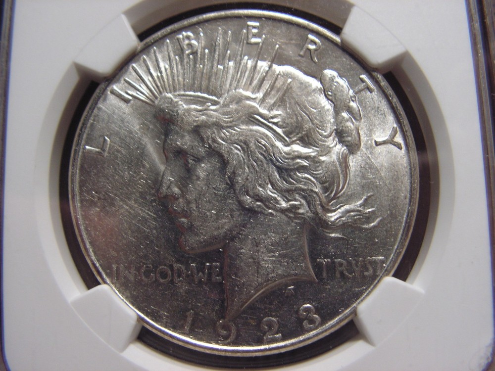 1923 - D Peace Silver Dollar. NGC AU58,  b