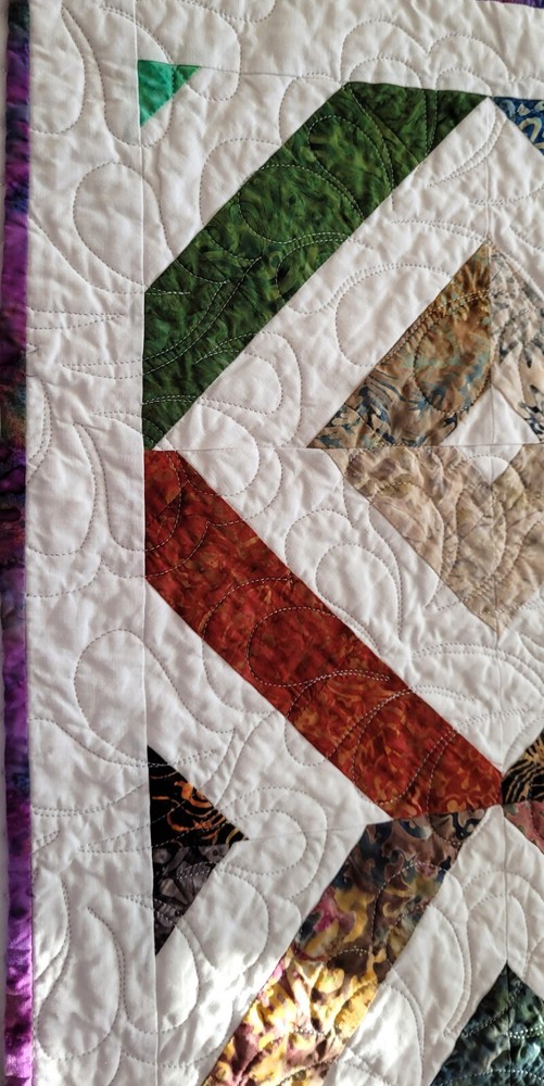 Hand made 55" X 62" Quilt In multiple batiks, purple batik back. Patchwork