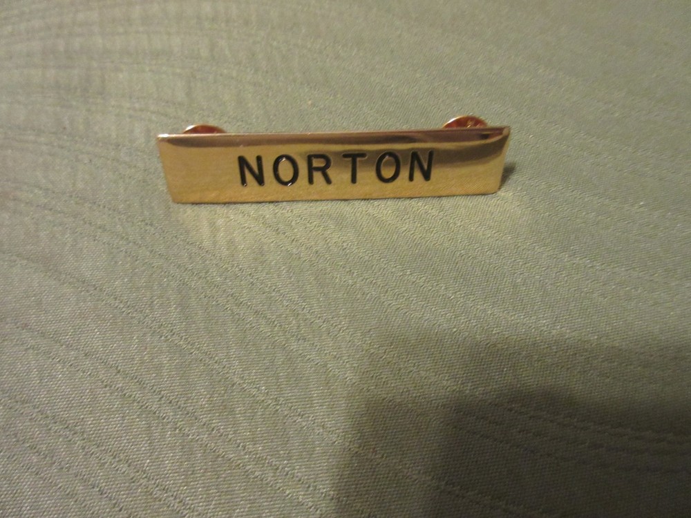NORTON GOLD TONE NAME TAG