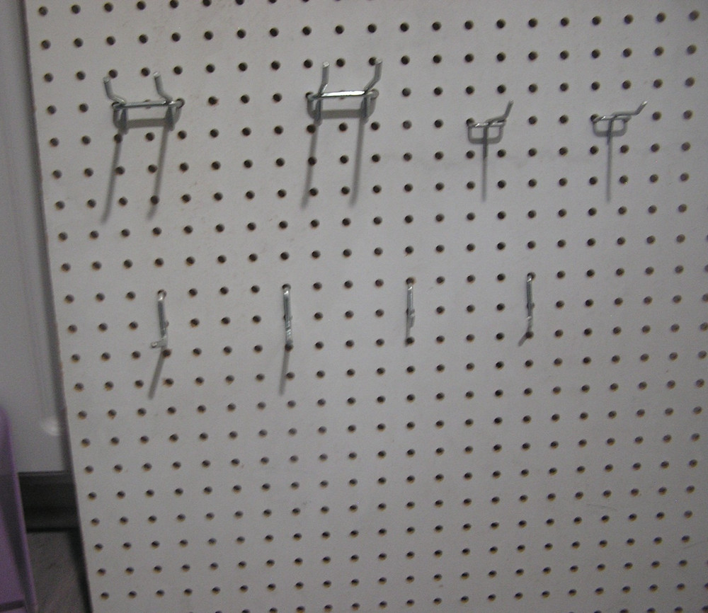 Composite Pegboard with Hooks and Bins Moounted