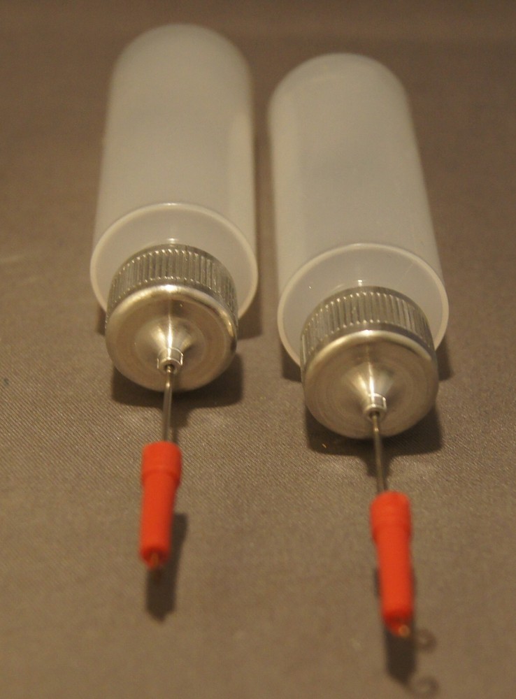 THREE PLASTIC SQUEEZE BOTTLES