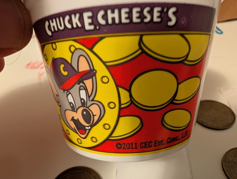 8. Old Chuck-E-Cheese Tokens And A Token Cup