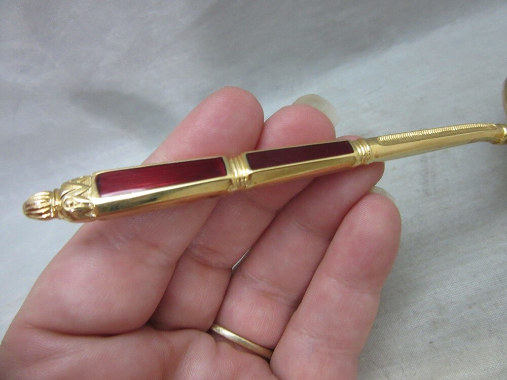 Gold plated cake server with red enamel handle
