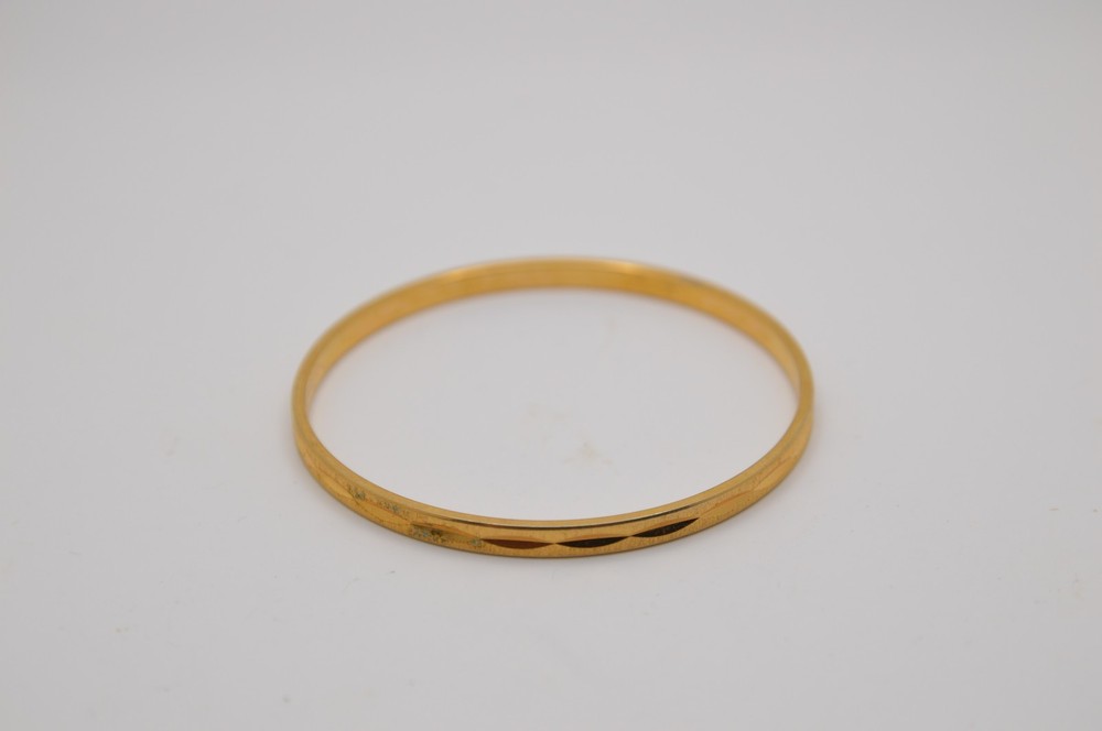 Thin gold bangle bracelet, signed Monet, 163