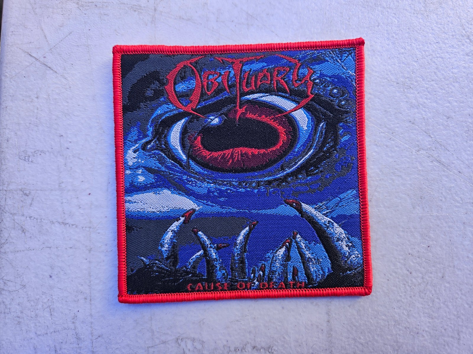 OBITUARY, CAUSE OF DEATH, SEW ON RED BORDER WOVEN PATCH