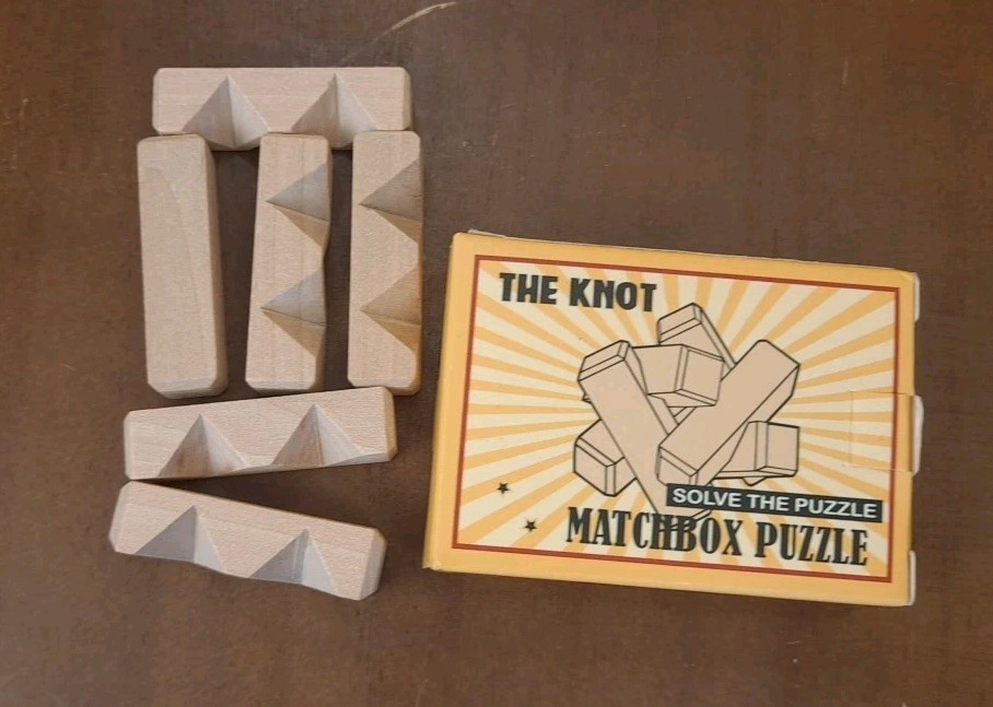 NIB The Knot Matchbox Puzzle Game 6 Pieces With Solution Inside - 2 1/2"