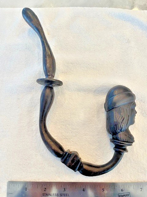 Antique figural hook with a man's face