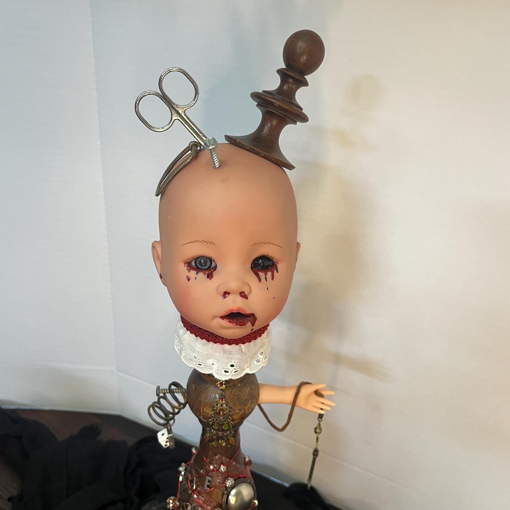 Creepy doll with scissors and key