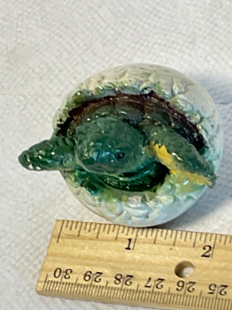 Hatching baby turtle figurine aged wear