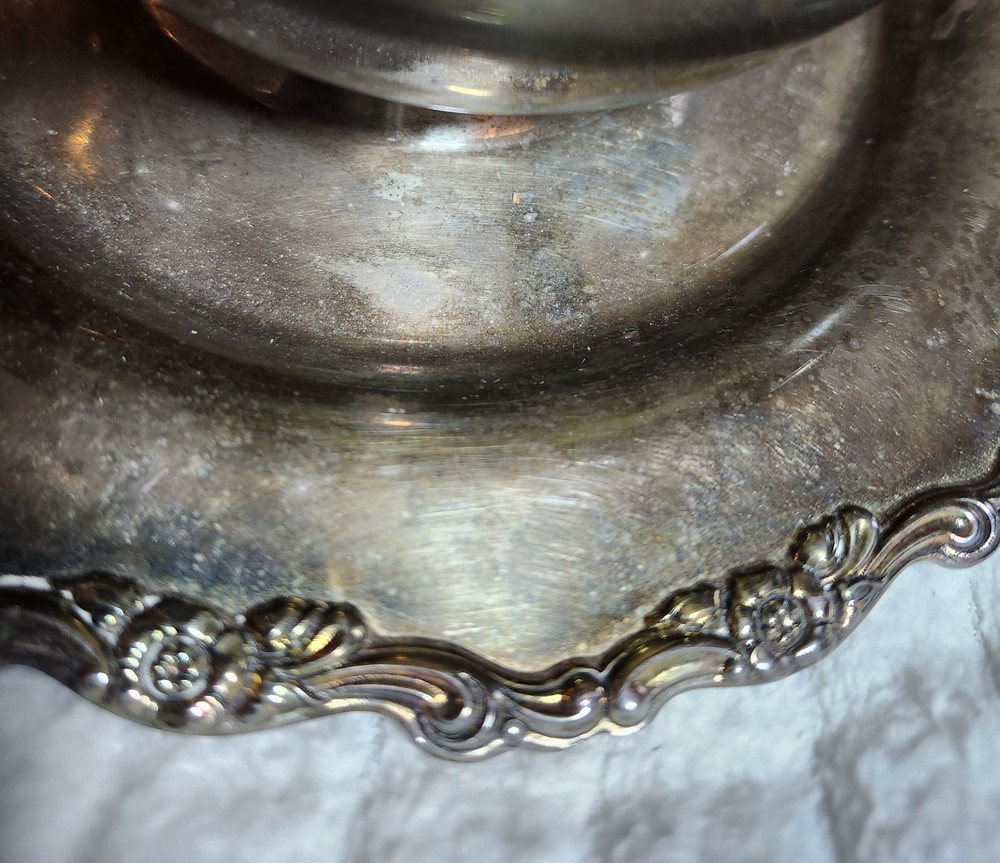 Silver-plated ornate bowl with attached underplate, possibly Oneida or Wallace.