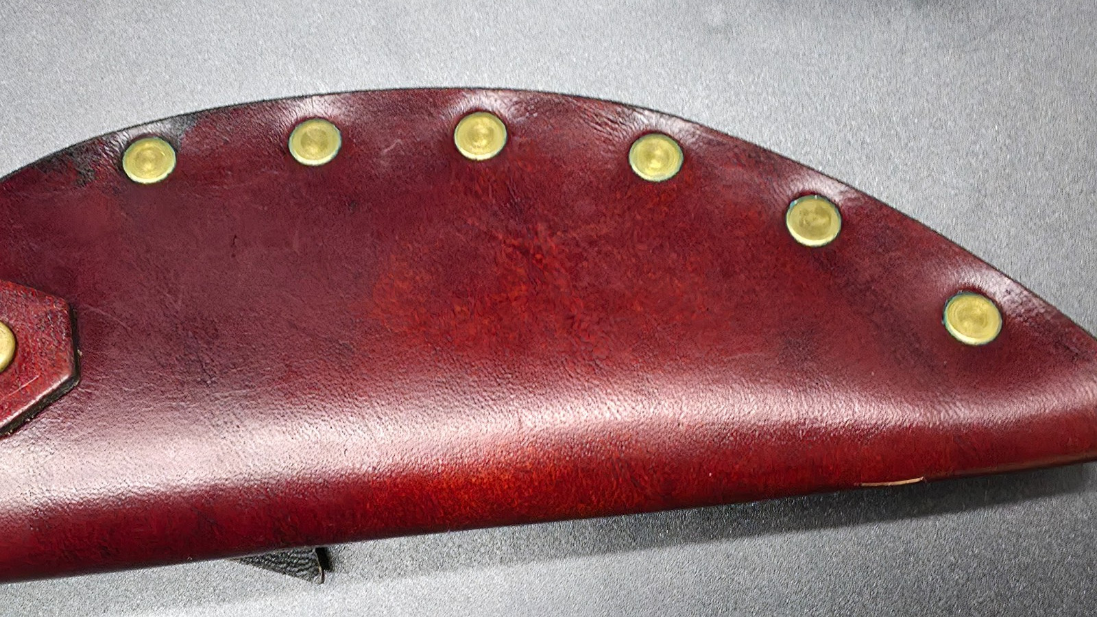 Buck Kalinga knife with black handle and brown leather sheath