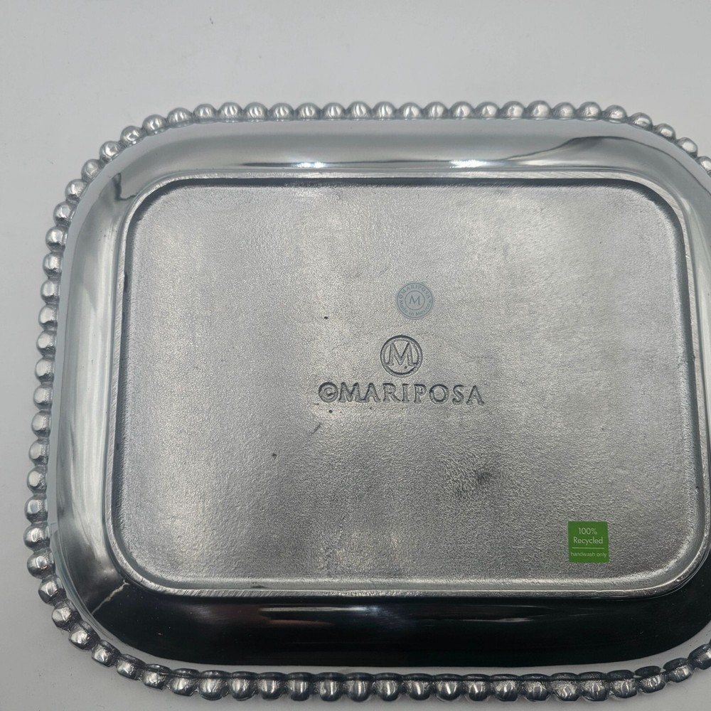 Rectangular platter with beaded edge. Made from recycled aluminum. Imported.