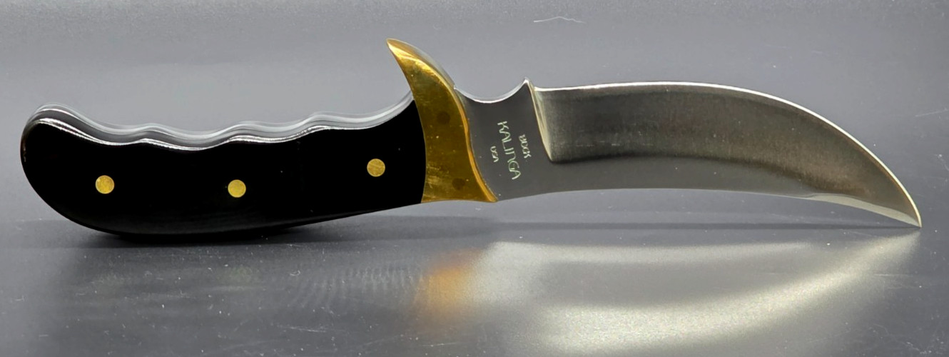 Buck Kalinga knife with black handle and brown leather sheath