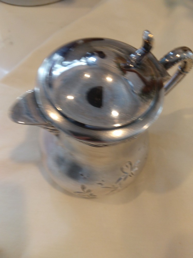 Beautiful small antique silver plated or silver pitcher.
