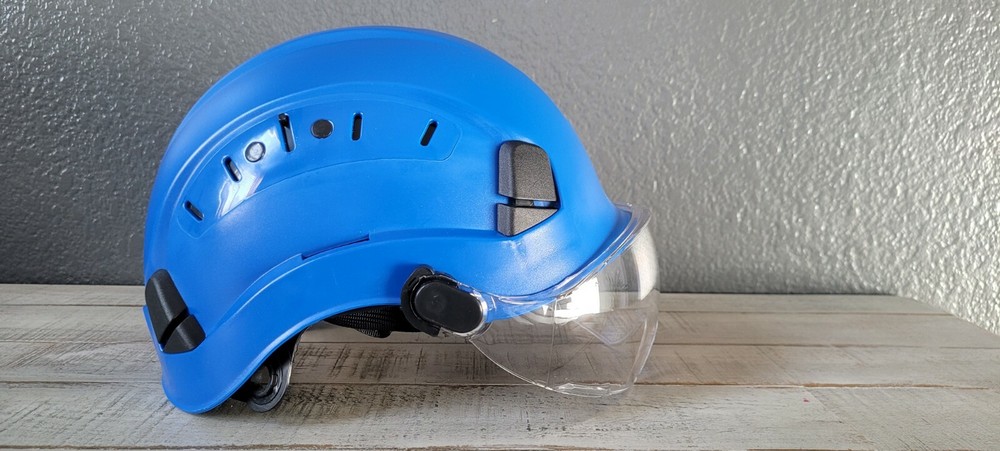 Arborist climber helmet with eye protection visor.