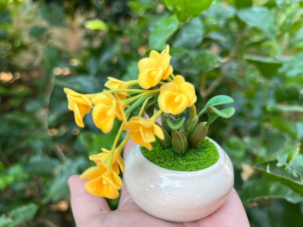 Tiny yellow orchids made by hand from clay