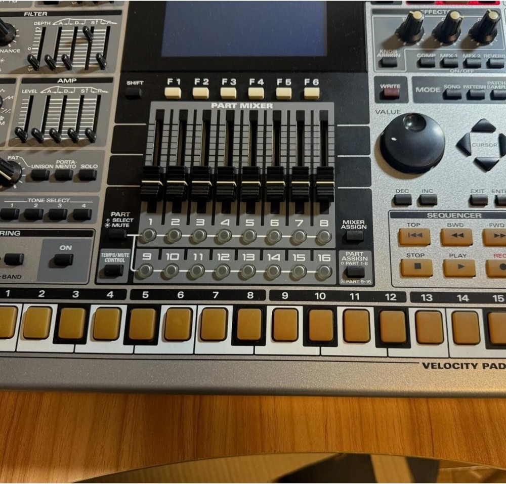 Roland MC-909 rhythm machine with adapter
