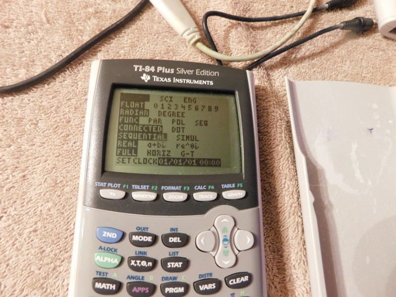Texas Instruments TI-84 Plus Silver Edition Graphing Calculator & Manual Cords