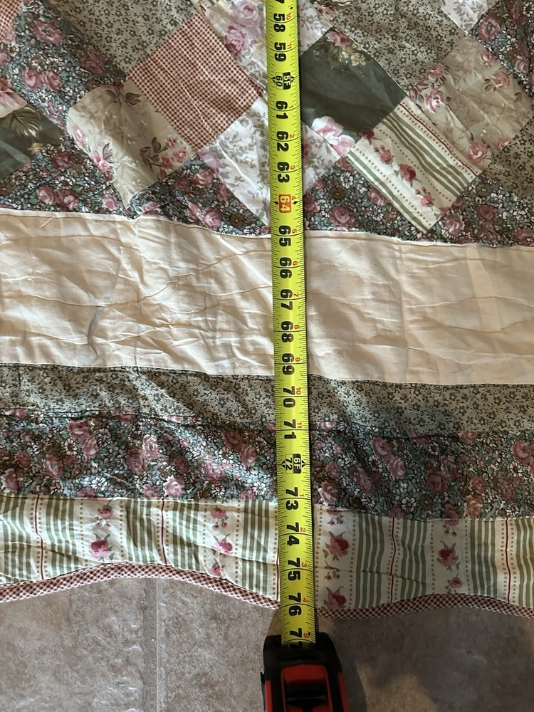 Cutters Handmade floral and striped patchwork quilt with diamond pattern.