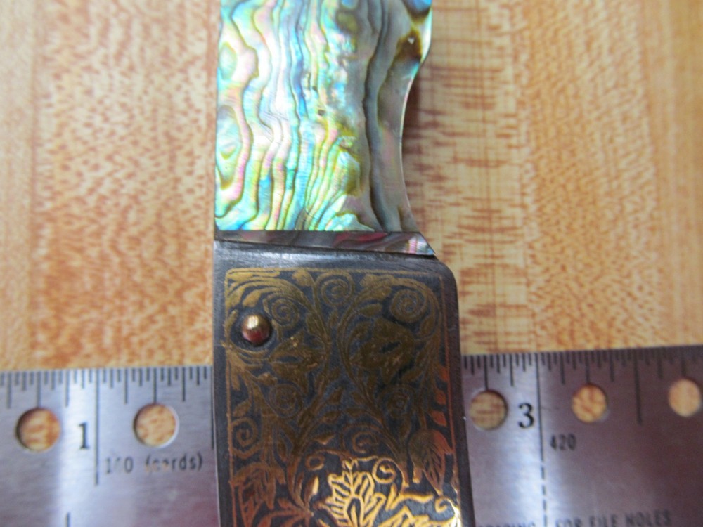 Custom Damascus folding knife. Abalone and gold leaf handles