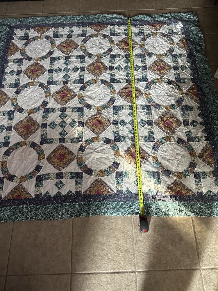 Cutters Handmade vintage quilt with floral and geometric patchwork patterns.