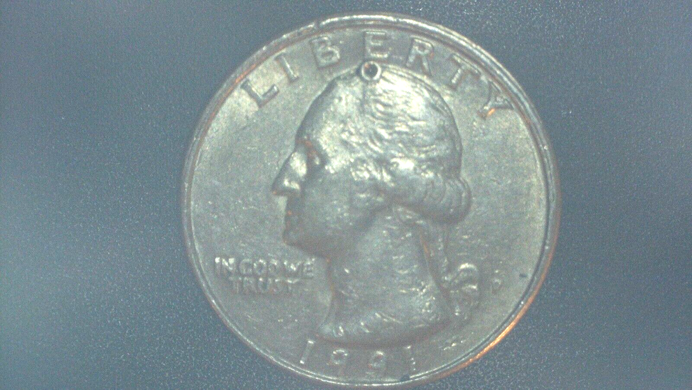 1991 Washington Quarter with a (strike through)