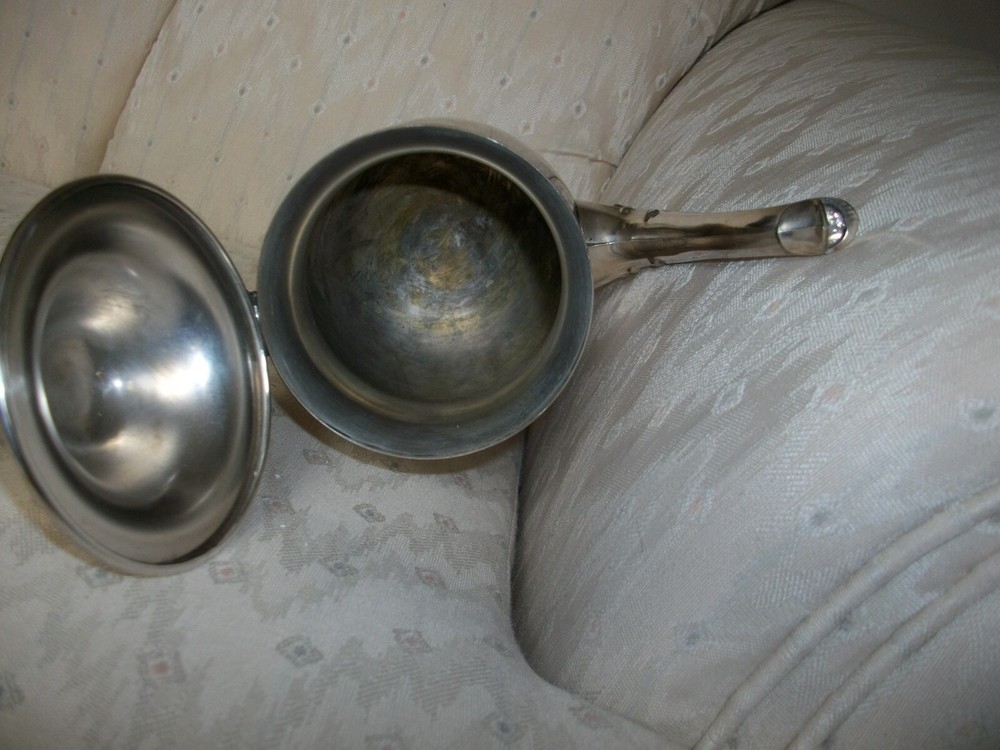 Silver coffee pot with insulated handle round bottom