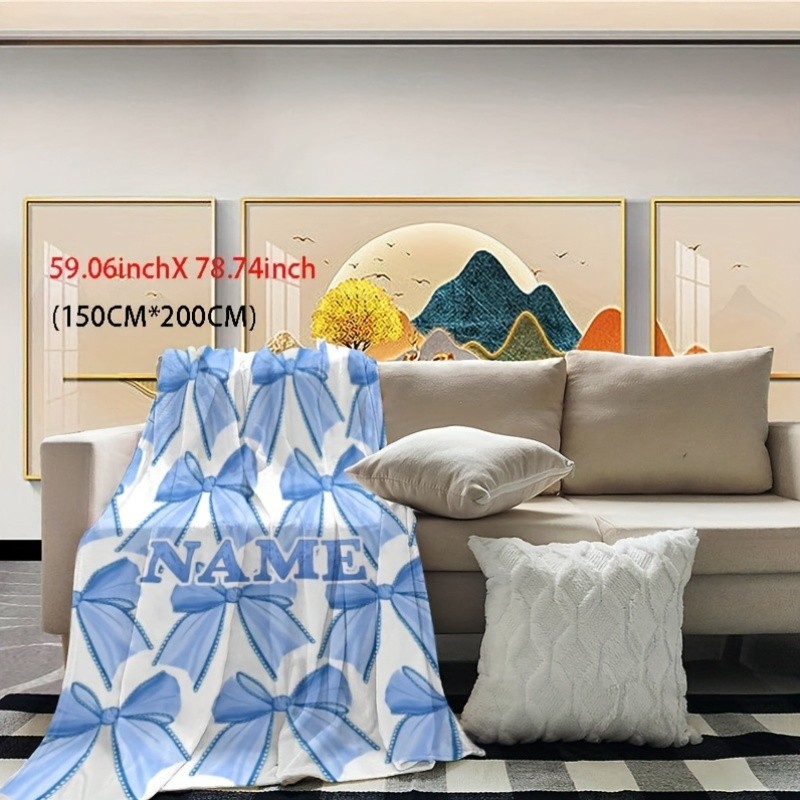 Customizable light blue flannel blanket with name and bow pattern♢