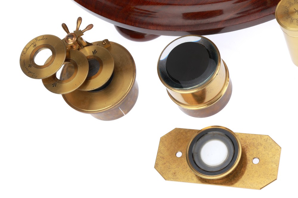 Very large binocular microscope in case with accessories.