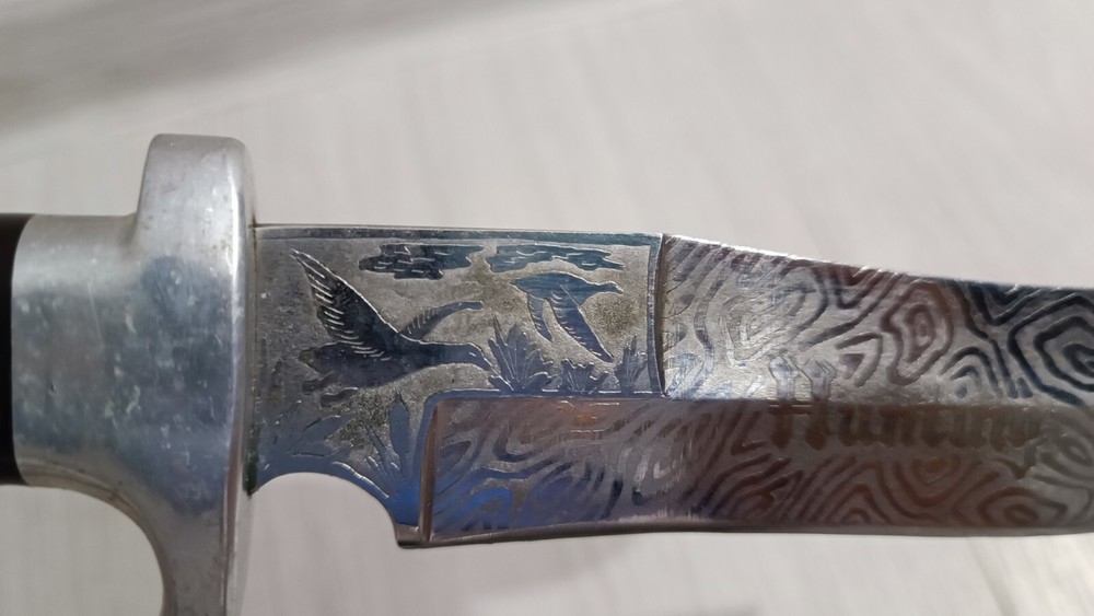Antique handmade hunting knife with a pattern.