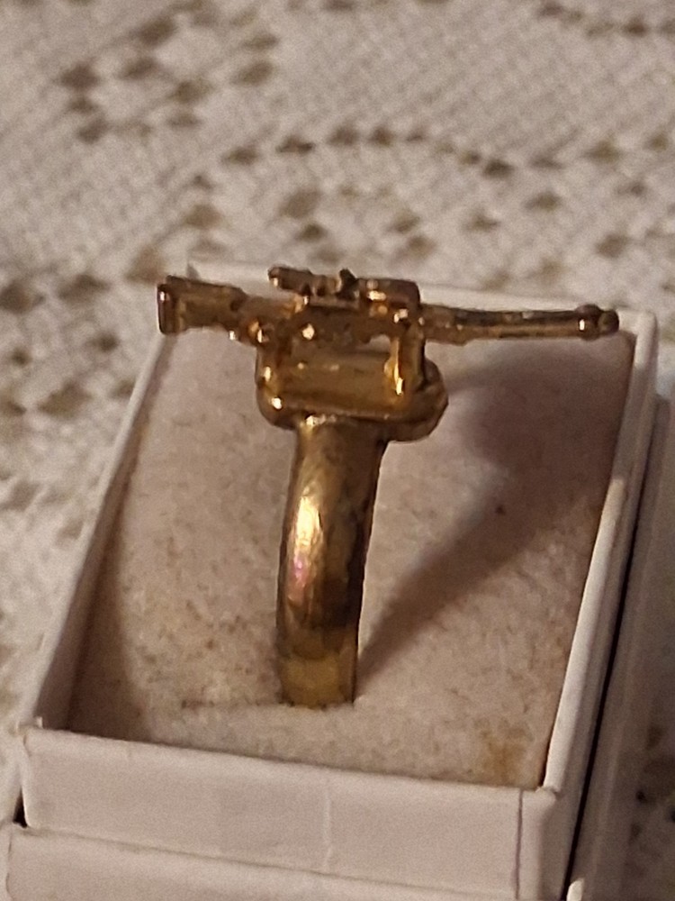 Early 40's to late 50's gold gun ring. Military based