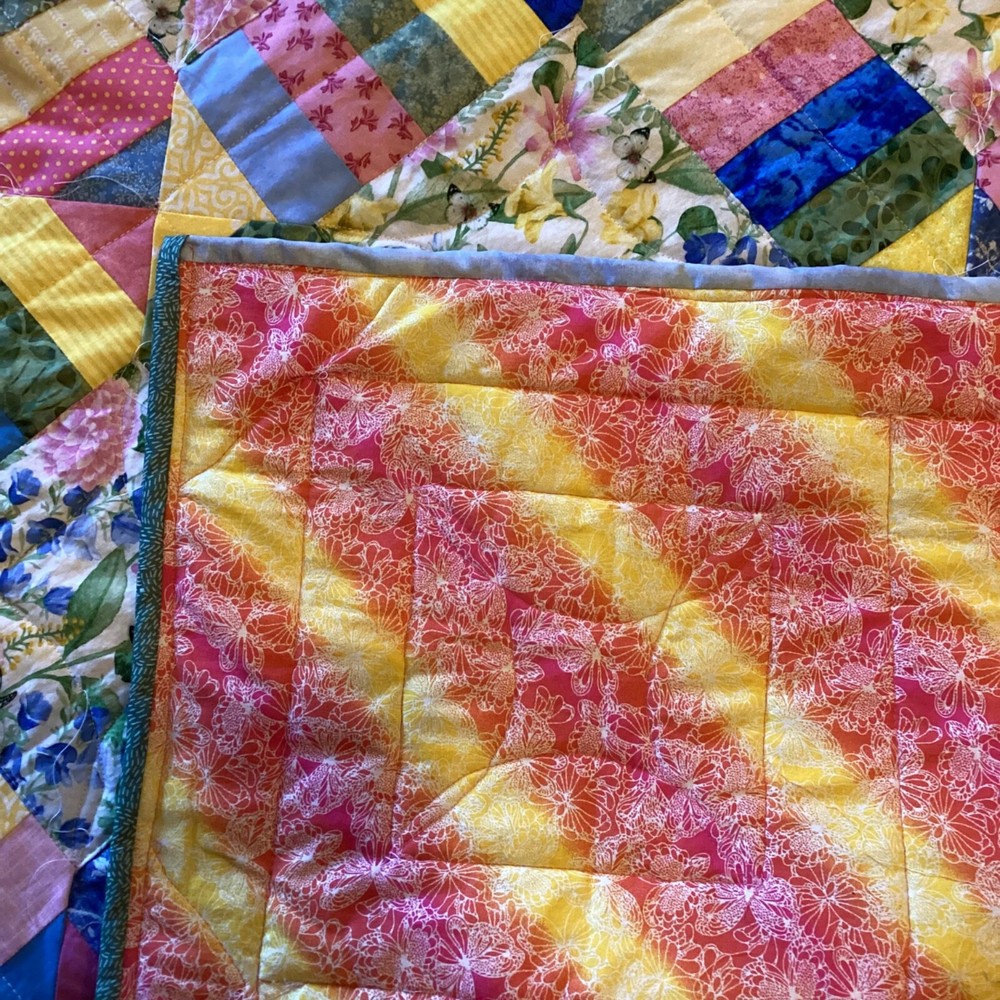Handmade colorful scrap lap quilt