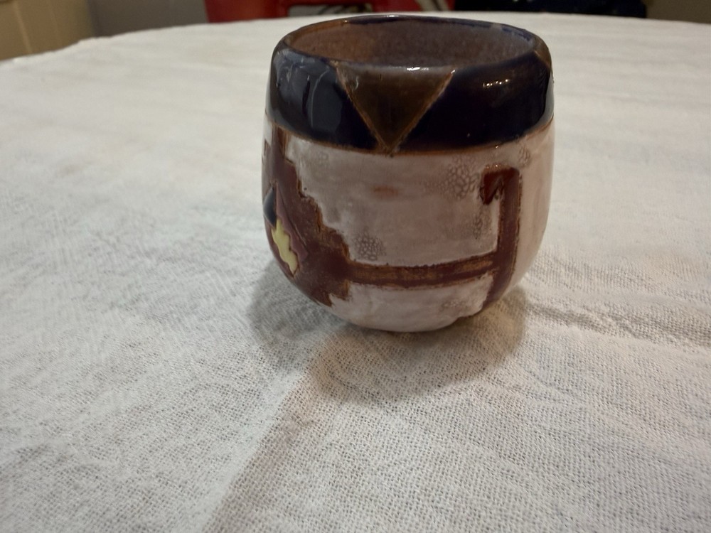 Handmade clay pottery with a distinct glazed finish.