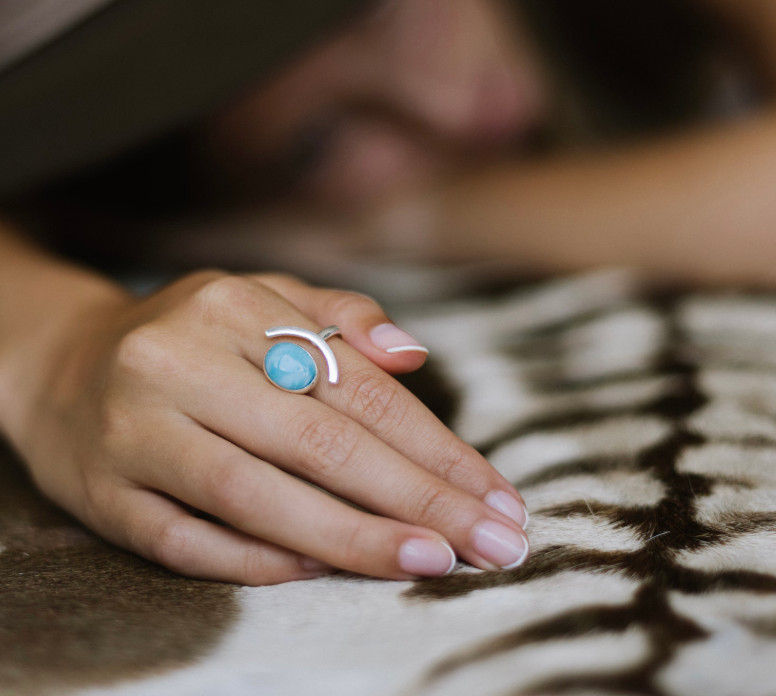 Adjustable Larimar ring with oval stone and silver designed in curved shape