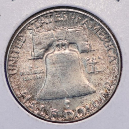 1952 About Uncirculated toned 90% silver Franklin half dollar.