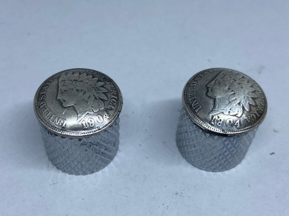 Silver toned Indian penny guitar knobs with knurled sides.