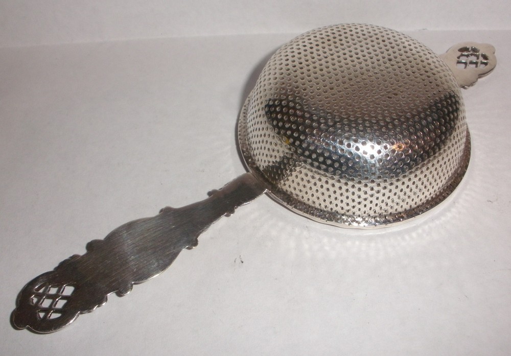 Nice Antique Continental silver flowers repousse tea strainer