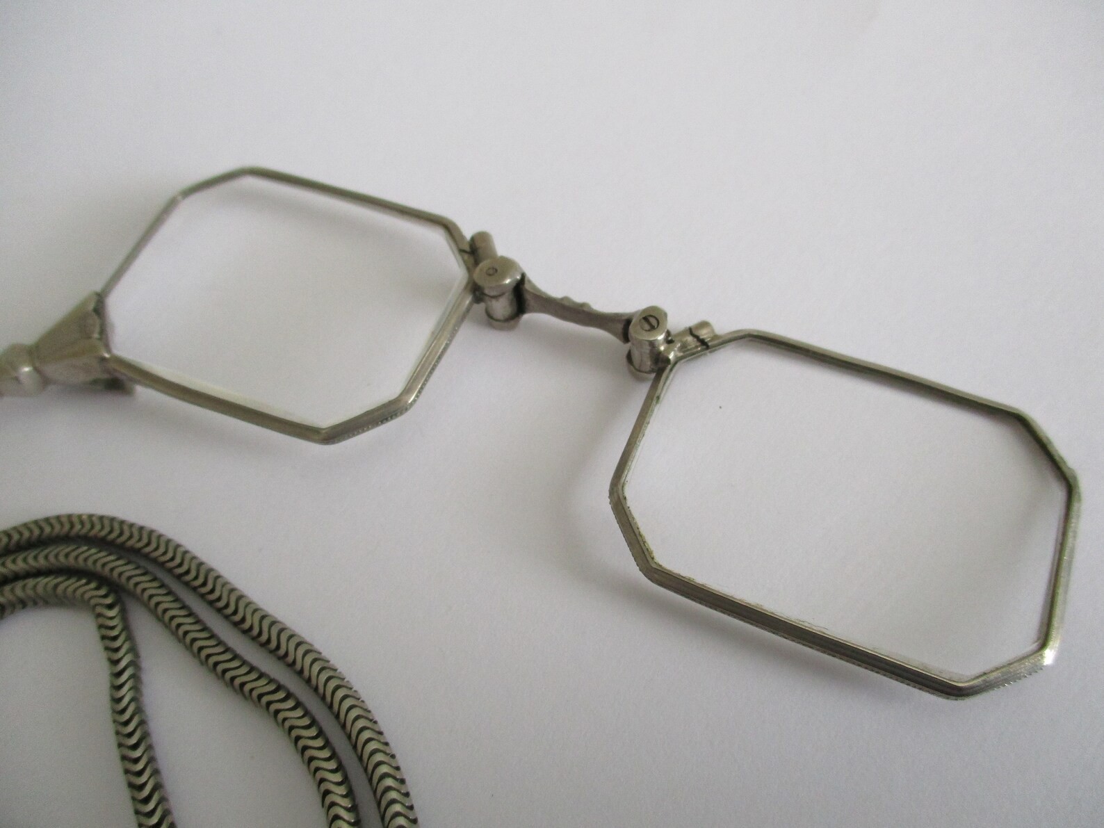A Deco style lorgnette with guard chain