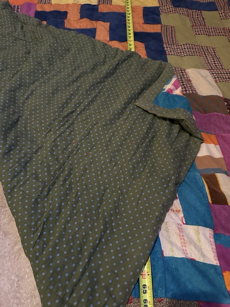 Handmade patchwork quilt with geometric 'L' block pattern.