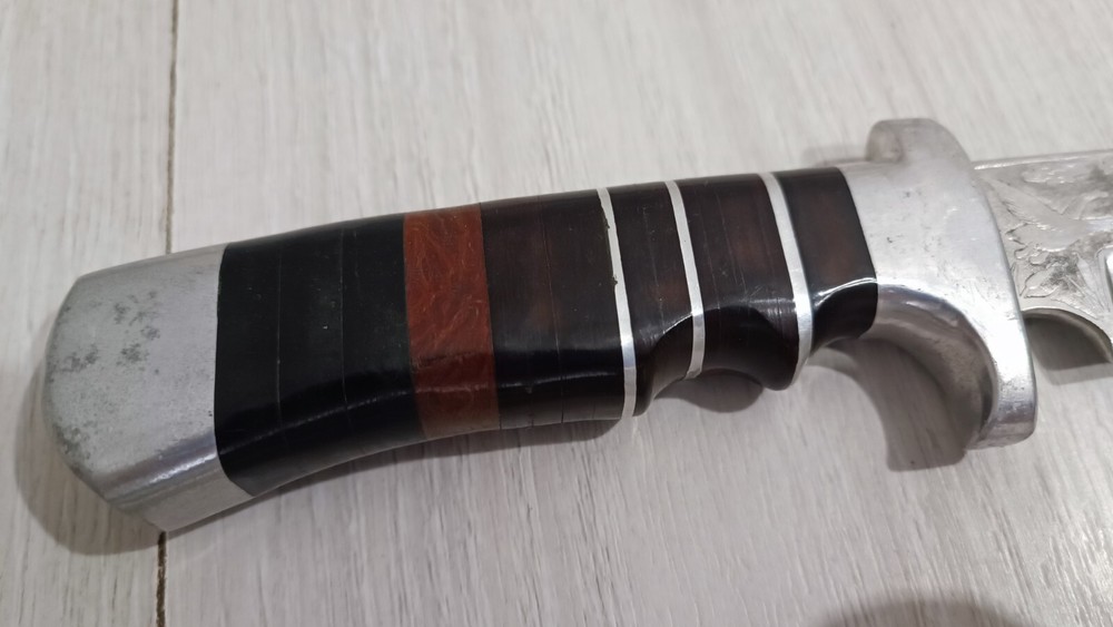 Antique handmade hunting knife with a pattern.