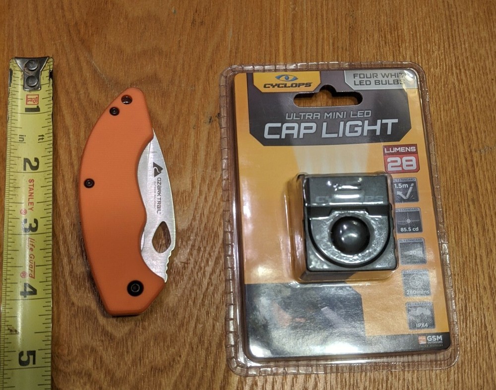 Lot - Cyclops Cap Light and Ozark Trail 6.5 in Titanium Folding Knife