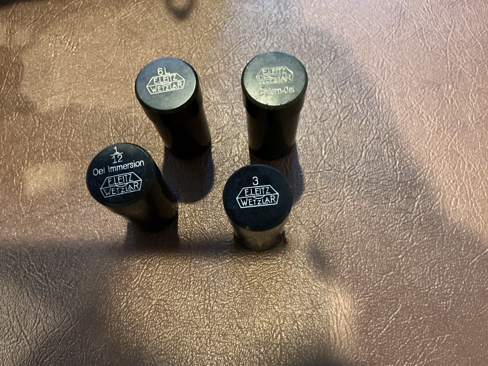 ERNST LEITZ MICROSCOPE WITH 3 OBJECTIVES AND CASE.