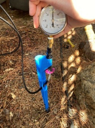 Drip irrigation pressure testing tool with 60 psi liquid filled gauge.