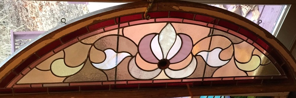 Antique arched stained glass window