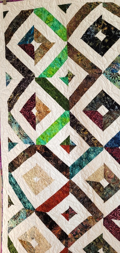 Hand made 55" X 62" Quilt In multiple batiks, purple batik back. Patchwork