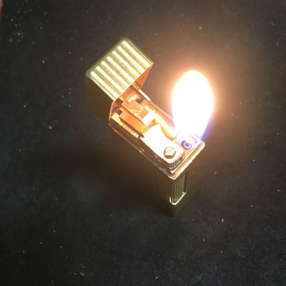 Overhauled gold dunhill lighter with striped pattern, ignition functioning well
